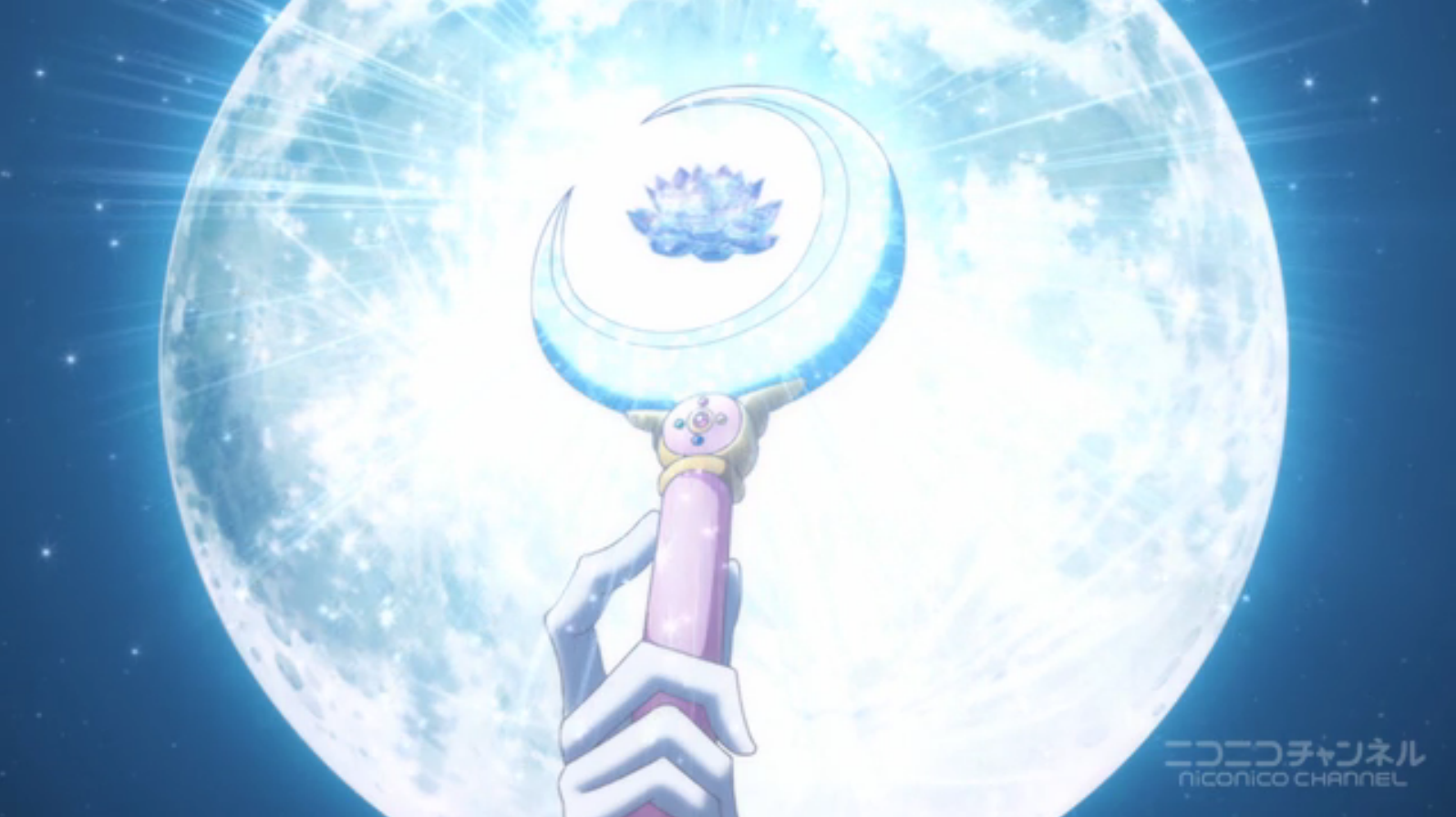the silver crystal sits in the moon stick in front of a full moon