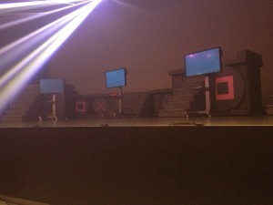 An empty stage with tv screens and video game consoles