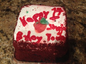 a small red velvet cake with the words "Happy 1st Birthday Shojo Power!"