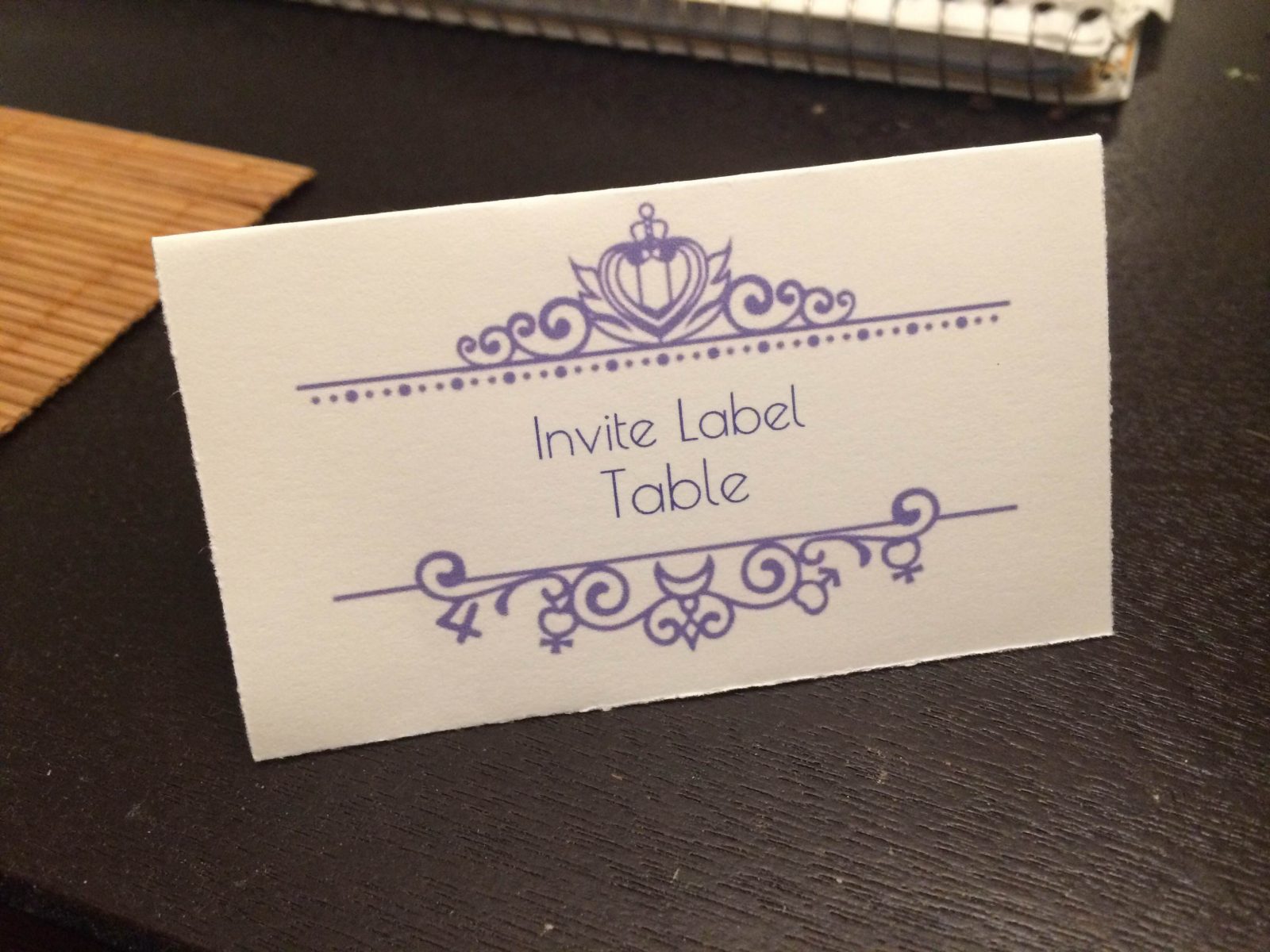 a name card with a purple Anna Sui design