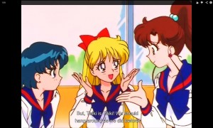 Ami, Minako and Makoto sit at a cafe