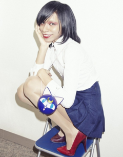 Avu-chan wearing a white shirt with a blue skirt with red heels with a Luna P ball