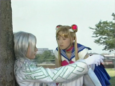 Zoisite leans against a tree while Sailor Moon leans over him