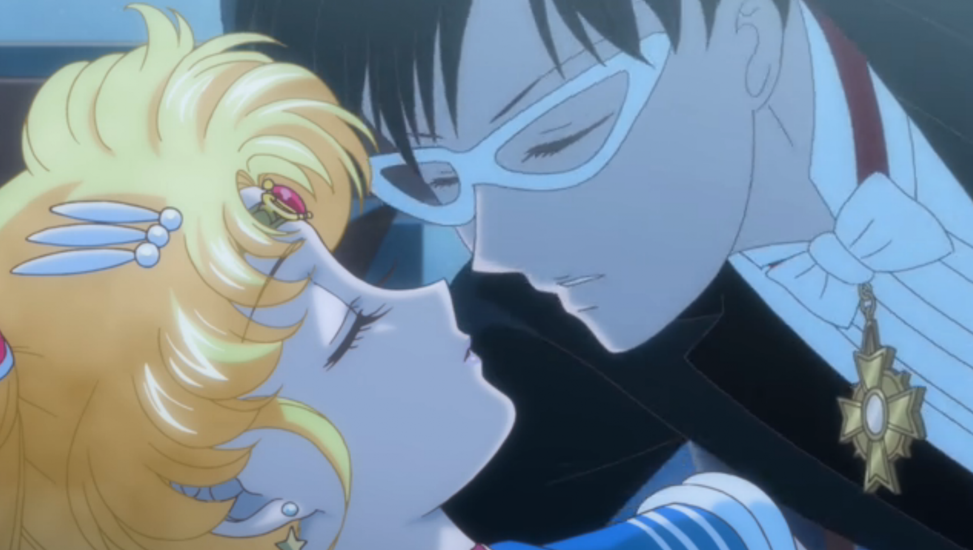 Tuxedo Mask leans over to kiss a sleeping Sailor Moon