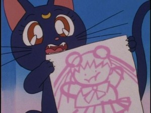 Luna holds up a drawing of a fat Sailor Moon