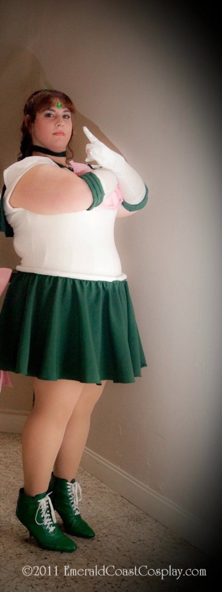 A fat white woman stands stoically in a Sailor Jupiter costume